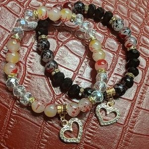 Two beaded bracelets with charms